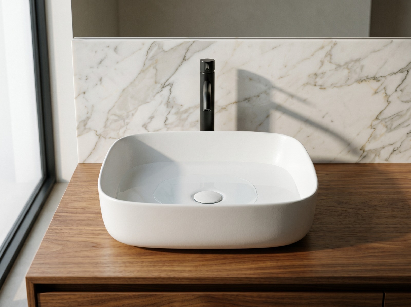White ceramic vessel basin with black faucet on a wood vanity