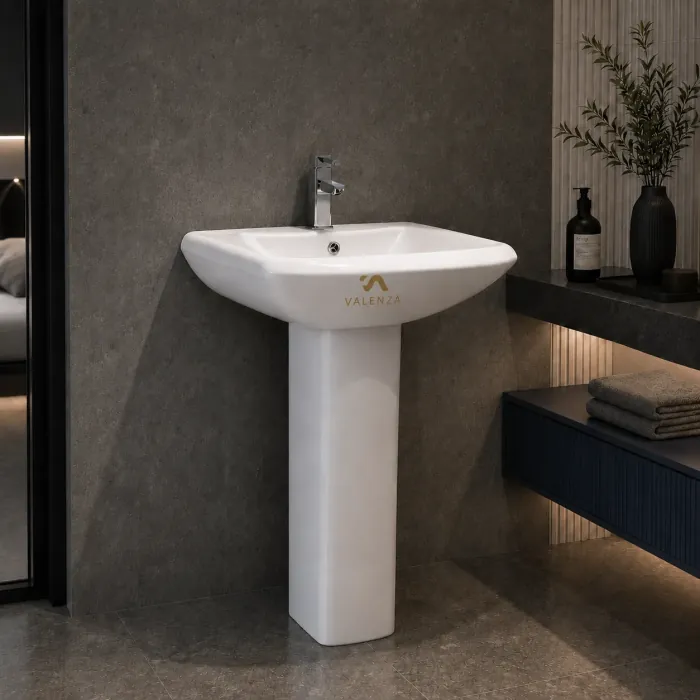 Pedestal basin with a softly squared bowl on a straight column in white ceramic