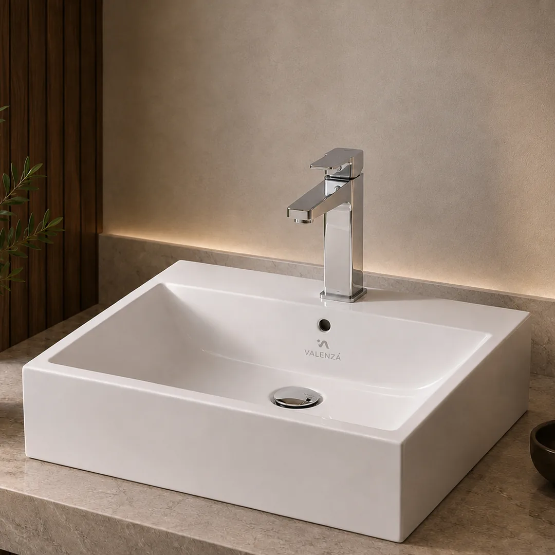 Deep rectangular white basin with a squared chrome mixer on a stone top