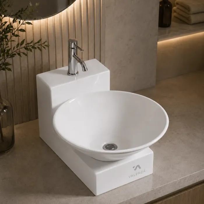 Round vessel basin resting on a stepped ceramic base with a chrome mixer