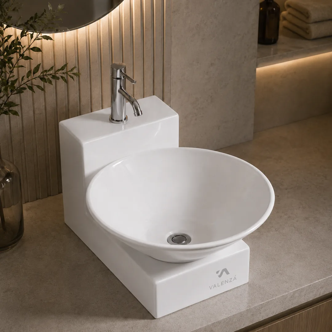 Round vessel basin resting on a stepped ceramic base with a chrome mixer