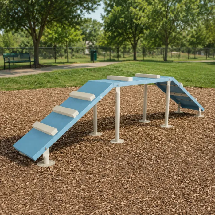 Blue A-frame dog ramp with pale steps over wood mulch