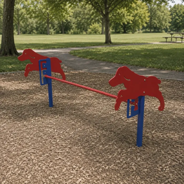 Red seesaw with dog silhouettes on blue posts over wood mulch