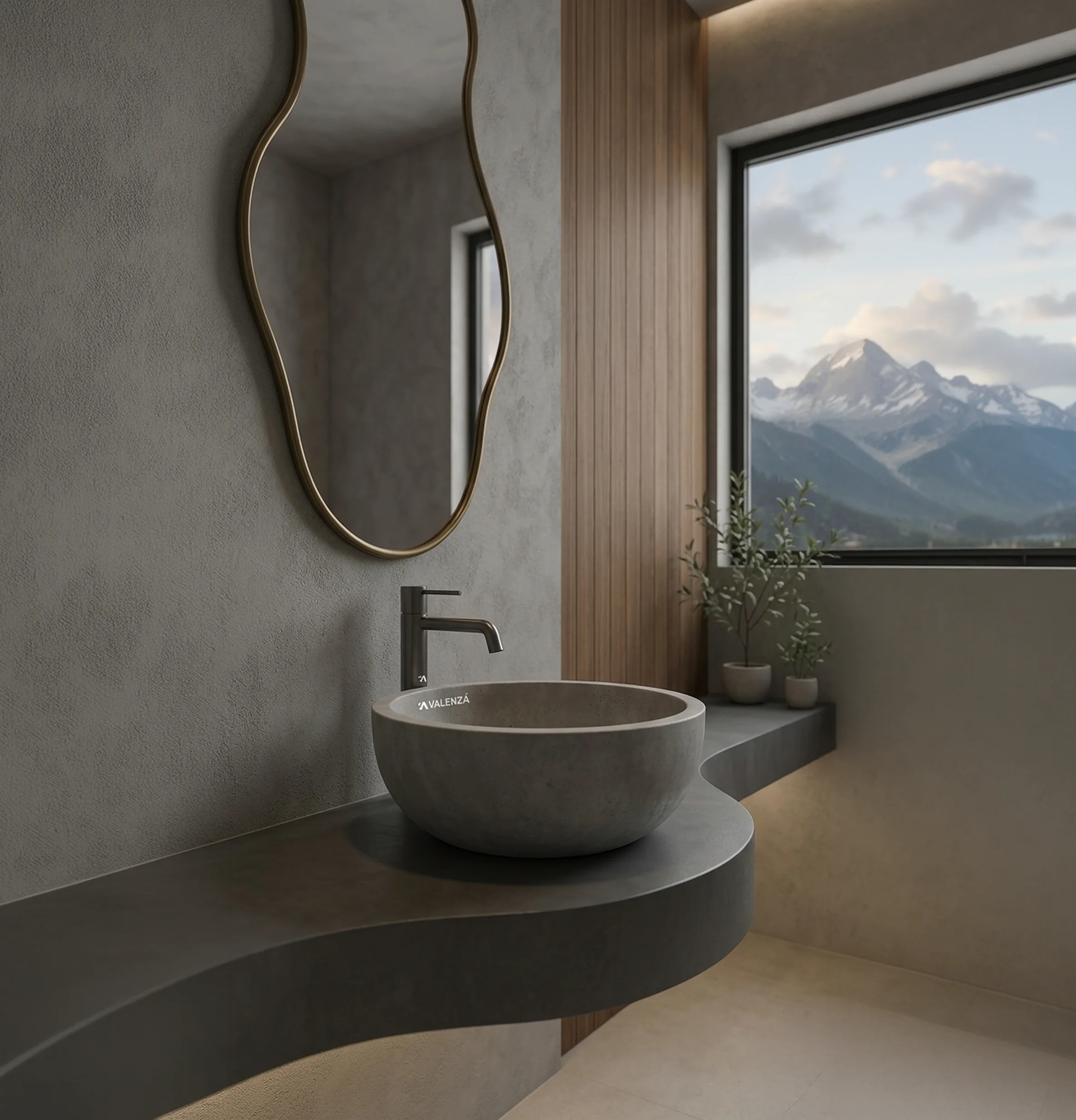 Modern bathroom with organic stone basin, brass-framed mirror, and mountain view