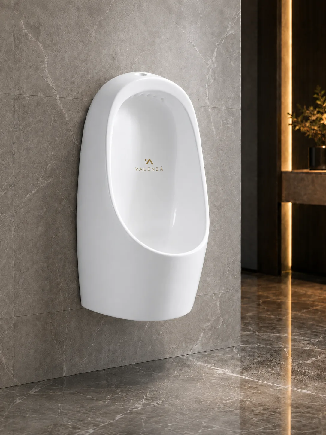 Rounded wall-hung urinal in white ceramic against grey marble